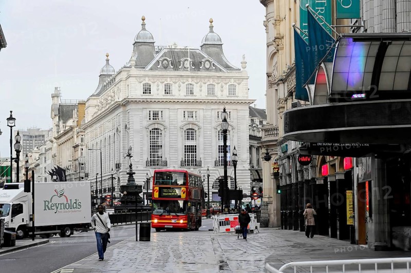 London, England, Great Britain, Europe, Red double-decker bus in a city street in front of historic architecture