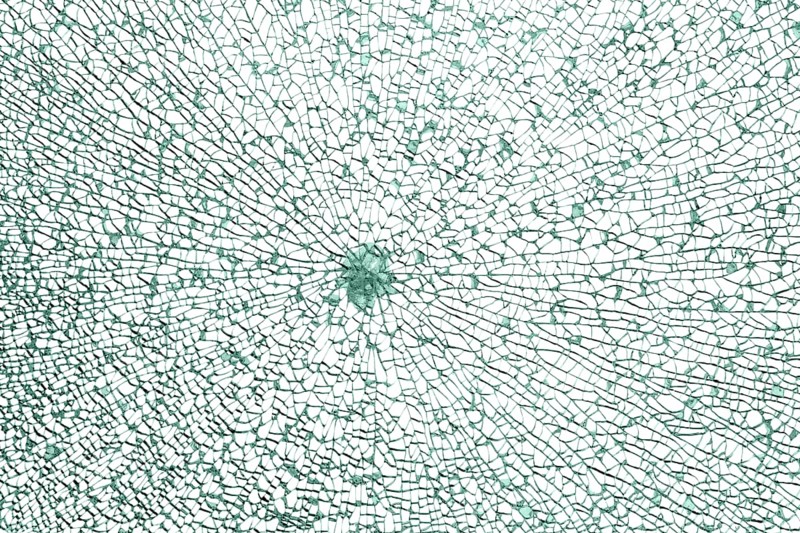 Full frame shot of a broken safety glass pane in white back