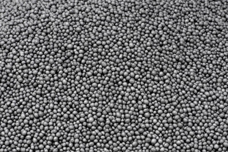 Full frame closeup showing lots of dark polystyrene beadlets