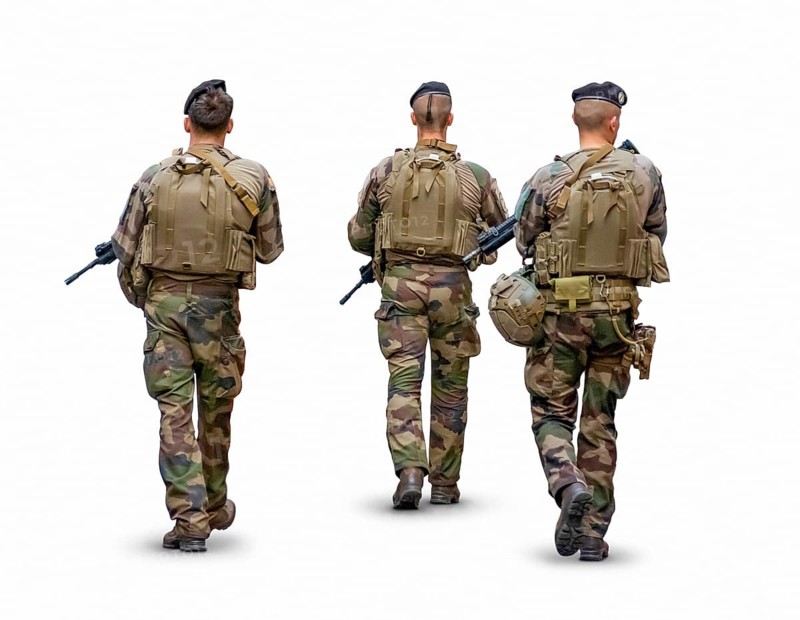 Rear view of a three person military patrol isolated in white back with shadow
