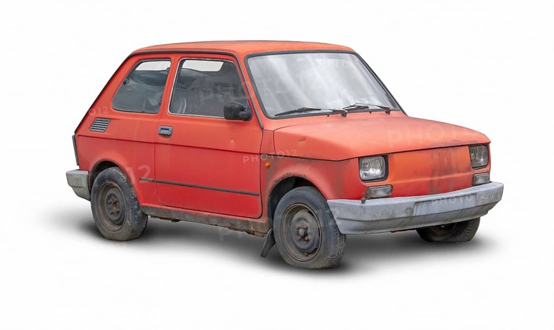 Small rundown red compact car in white back with shadow
