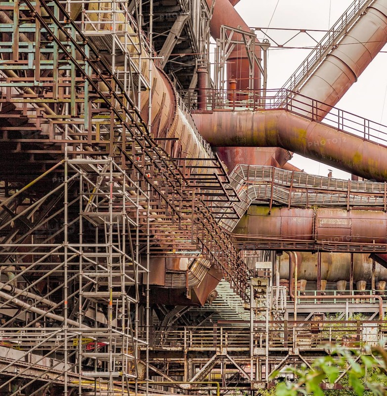 Weathered rusty industrial scenery with old corroded steel girders and metal tubes