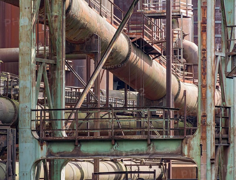 Weathered rusty industrial scenery with old corroded steel girders and metal tubes