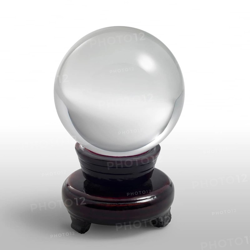 A clear crystal ball and stand in light grey gradient back