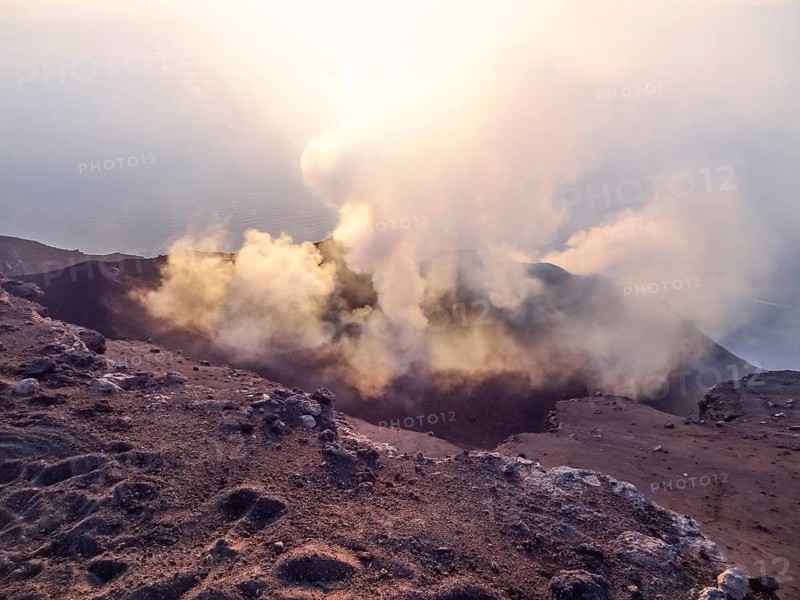 Smoky crater scenery at Stromboli volcano near Sicily at evening time