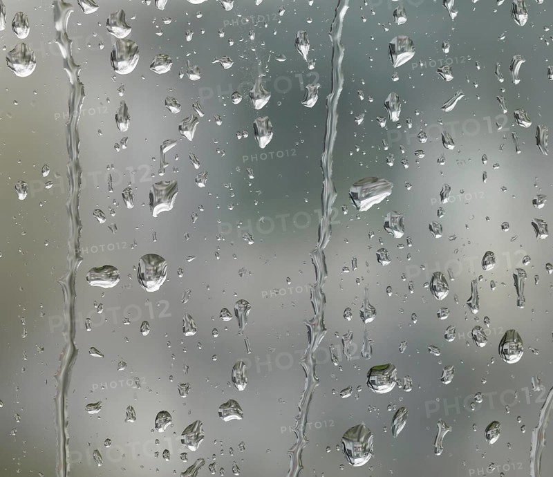 Detail of roll off raindrops on window glass