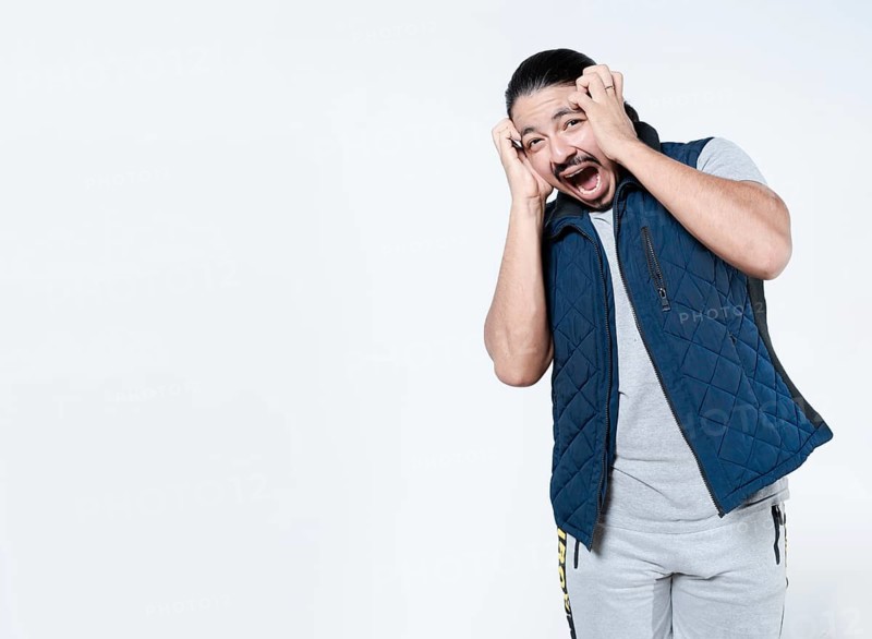Horrified man with holding his face on isolated background