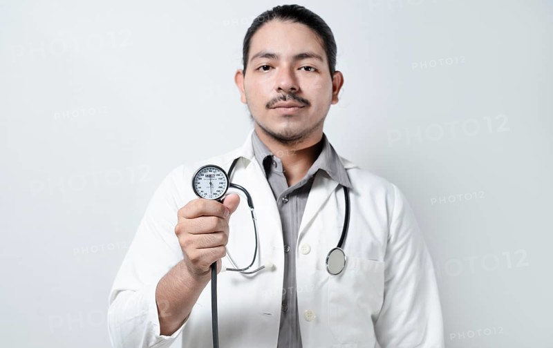 Doctor showing blood pressure monitor isolated. Male doctor holding tensometer
