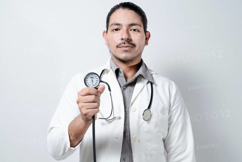 Doctor showing blood pressure monitor isolated. Male doctor holding tensometer