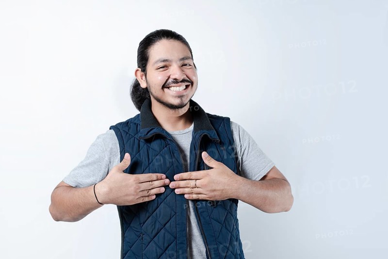 Smiling man with hands on chest on isolated background