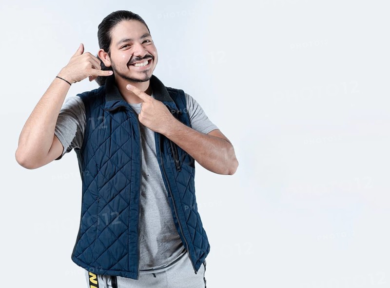 Smiling man gesturing call me on isolated background. Young man makes a calling gesture on a white background