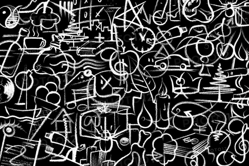 Lots of white crayon painted symbols on dark board