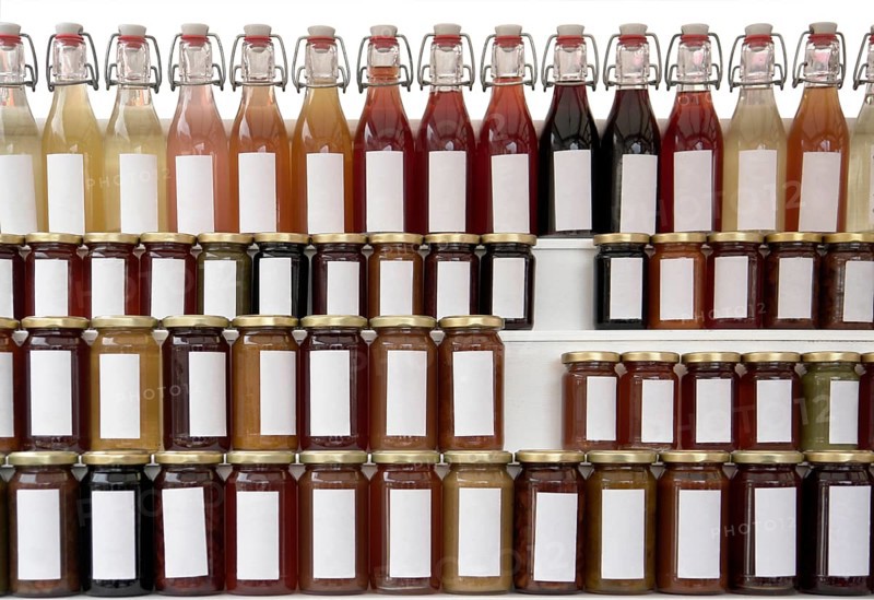 Lots of preserving glasses and bottles filled with colorful content
