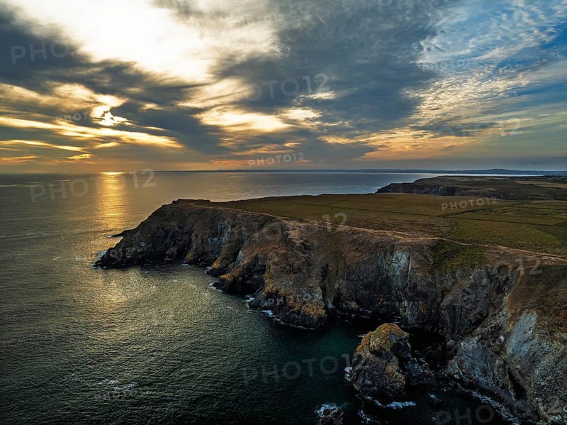 Sunset over Kynance Cove from a drone, Mount's Bay, Lizard Point, Cornwall, England, United Kingdom