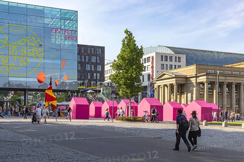 Twelve houses in bright magenta stand on Stuttgart's Schlossplatz in front of the art museum. The Pforzheim-based architecture artist Andreas Sarow developed the Exkursion art project. Stuttgart, Baden-Württemberg, Germany