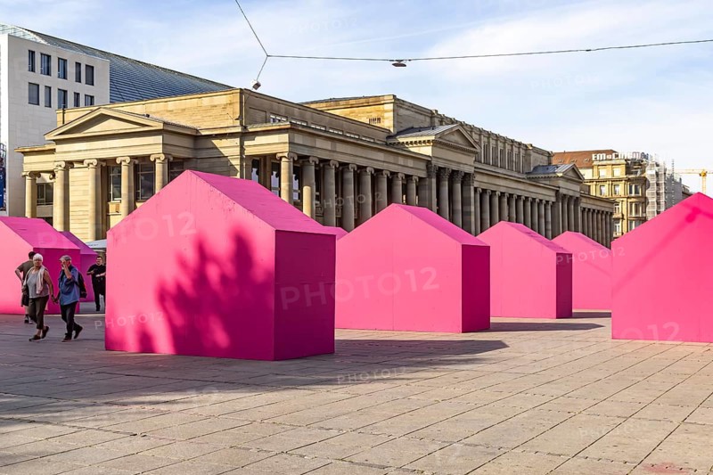 Twelve houses in bright magenta stand on Stuttgart's Schlossplatz in front of the art museum. The Pforzheim-based architecture artist Andreas Sarow developed the Exkursion art project. Stuttgart, Baden-Württemberg, Germany