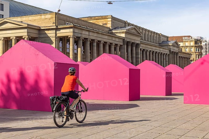 Twelve houses in bright magenta stand on Stuttgart's Schlossplatz in front of the art museum. The Pforzheim-based architecture artist Andreas Sarow developed the Exkursion art project. Stuttgart, Baden-Württemberg, Germany