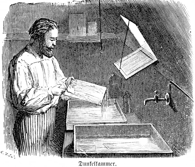Darkroom, exposure of negatives on photographic paper, development of photos, glass, liquids, fixir bath, developer, water, tap, darkness, red light, dark room, man with beard, photographer, artist, inventions in the 19th century, technology, photography, historical illustration 1872, Germany
