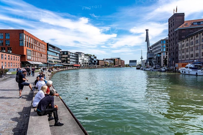 Münster's harbour district, known as Kreativkai, a lively quarter that has developed from a former goods handling area into a modern hotspot for art, culture, gastronomy and business, in converted warehouses combined with modern architecture, nightlife district, former inner harbour, on the Dortmund-Ems Canal, North Rhine-Westphalia, Germany