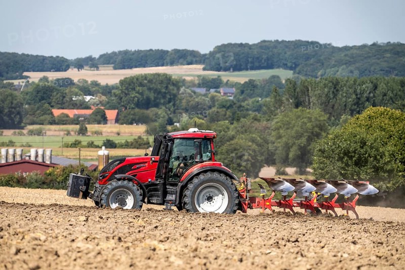 Tractor ploughs up a harvested grain field, south of Billerbeck in Münsterland, North Rhine-Westphalia, Germany