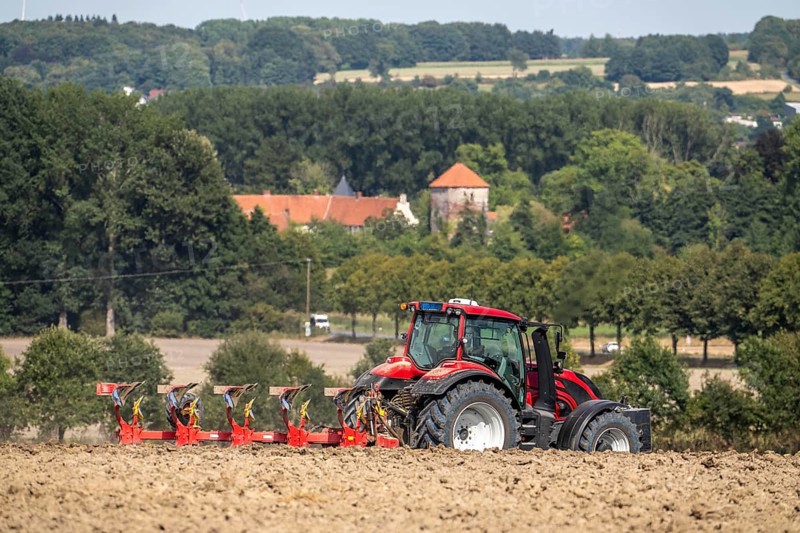 Tractor ploughs up a harvested grain field, south of Billerbeck in Münsterland, North Rhine-Westphalia, Germany
