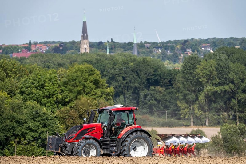 Tractor ploughs up a harvested grain field, south of Billerbeck in Münsterland, North Rhine-Westphalia, Germany