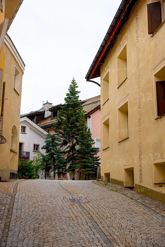 Beautiful Street in Old Town with a Tree in a Summer Day in Samedan, Grisons, Switzerland