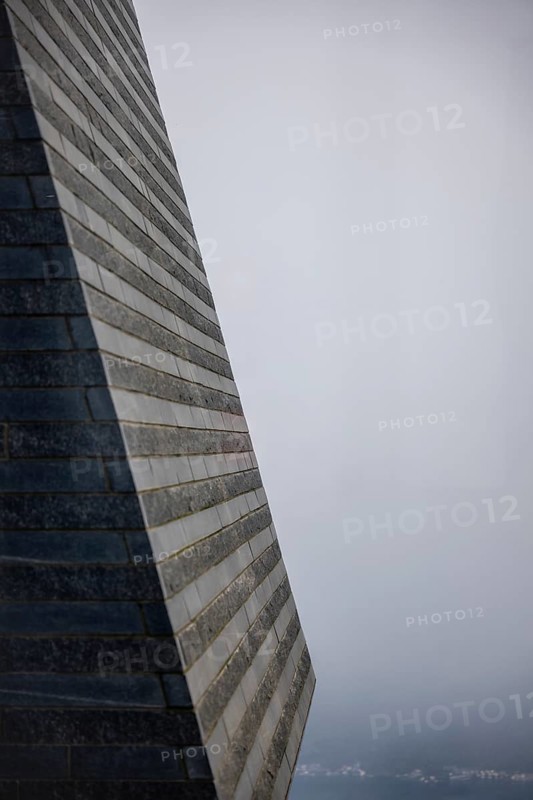 Modern Granite Wall in the Fog with Sunlight in Switzerland