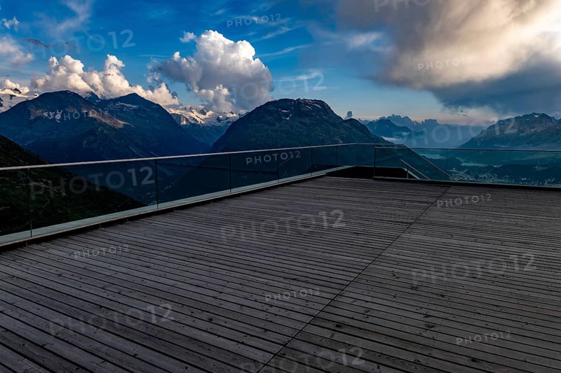 Beautiful Terrace View with Snow and over Alpine Lake and Swiss Alps and Cityscape in a Sunny Day with Blue Sky and Clouds in St Moritz, Maloja, Grisons, Switzerland