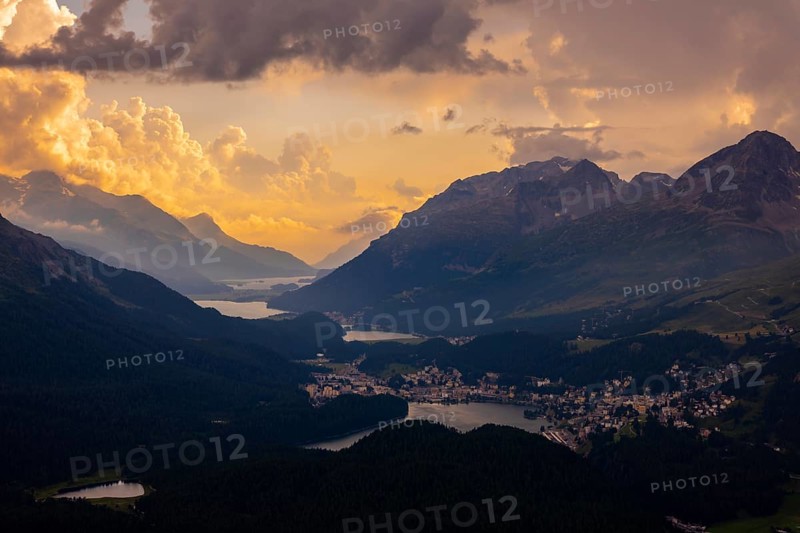 Beautiful Aerial View over Five Lakes and Swiss Alps and Cityscape in Sunset and Storm Clouds over St Moritz, Maloja, Grisons, Switzerland