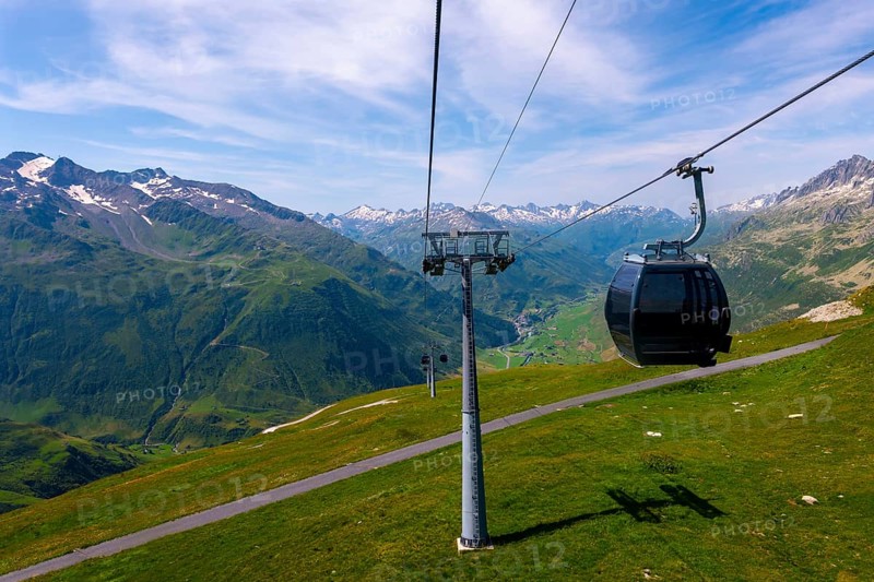 Beautiful Panoramic View From Overhead Cable Car over the Golf Course with Mountainscape and Mountain Valley in the Swiss Alps in a Sunny Summer Day in Andermatt, Uri, Switzerland