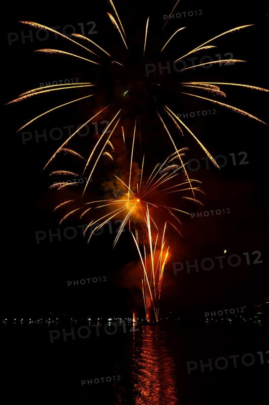 Beautiful Fireworks Display at Night over Lake Lugano in Ponte Tresa, Lombardy, Italy