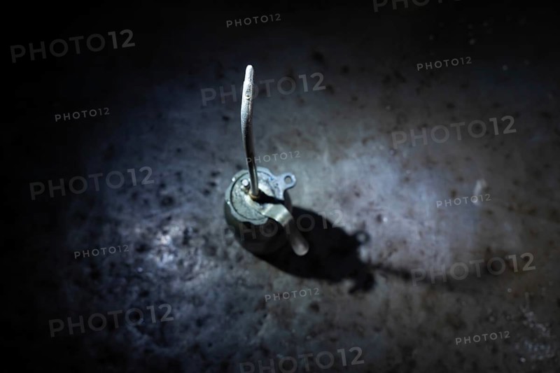 Old Dirty Oil Can with Sunlight and Shadow on a Metal Table in Mechanic Workshop in Switzerland