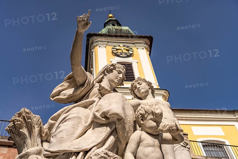 Group of figures of Mother Baar and the Catholic Church of St John in Donaueschingen, Baden-Württemberg, Germany