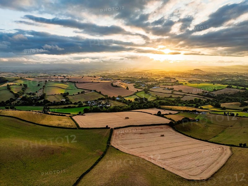 Sunset of Fields and Farms over Devon from a drone, Torquay, Torbay, Devon, England, United Kingdom