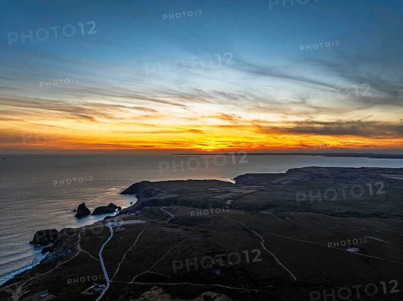 Sunset over Kynance Cove from a drone, Mount's Bay, Lizard Point, Cornwall, England, United Kingdom