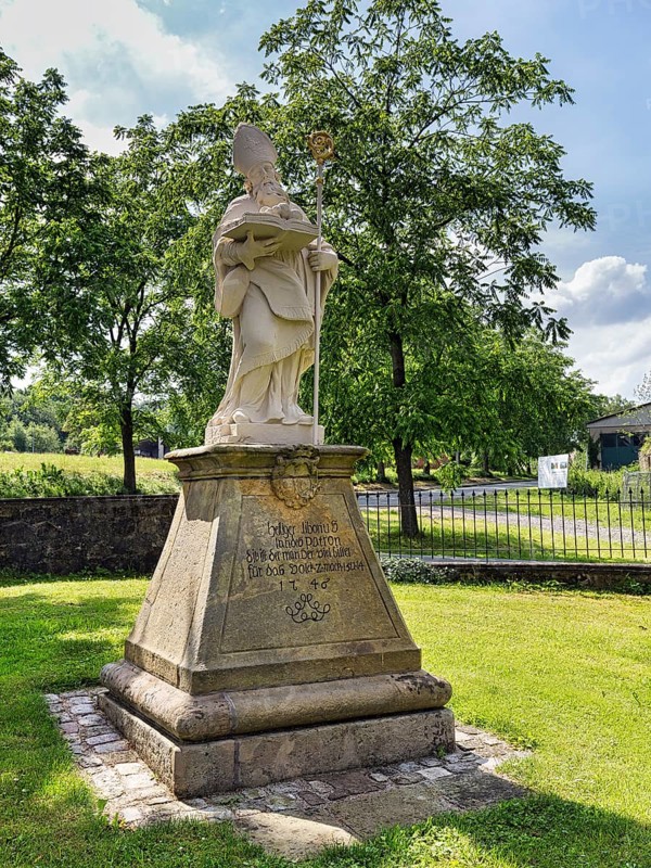 Saint Liborius, stone statue on a pedestal with inscription, parish church of St Maximilian, Willebadessen, Höxter, Teutoburg Forest nature park Park, North Rhine-Westphalia, Germany