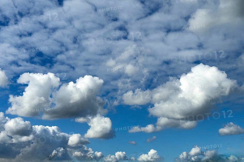 Several types of cumulus clouds white clouds, below and in the middle cumulus cluster clouds above them behind many cirrocumulus clouds, international