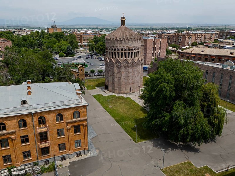 A round tower in an urban setting with surrounding trees and historic buildings, aerial view, Holy Archangel Church, Echmiadzin, Echmiadzin, Ejmiacin, Vagharshapat, Vagarshapat, Vagarshapat, Vagharshapat, Armavir Province, Armenia