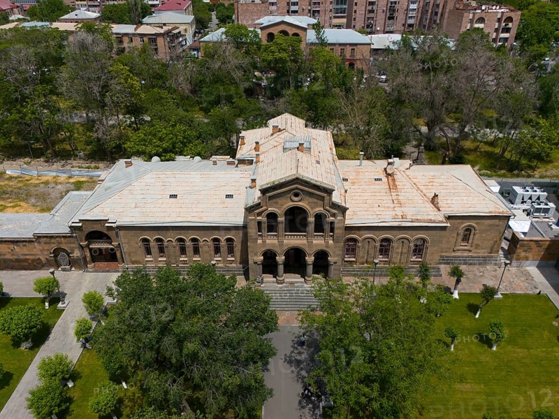 Historic building with classical façade surrounded by lush vegetation and urban area, aerial view, Christian Education Centre, Echmiadzin, Echmiadzin, Ejmiacin, Vagharshapat, Vagarshapat, Vagarshapat, Vagharshapat, Armavir Province, Armenia