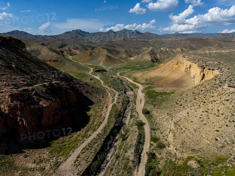 View over a vast desert landscape with mountains and a valley under a cloudy sky, aerial view, on the way to Angel's Canyon, Dashtakar, Ararat Province, Armenia
