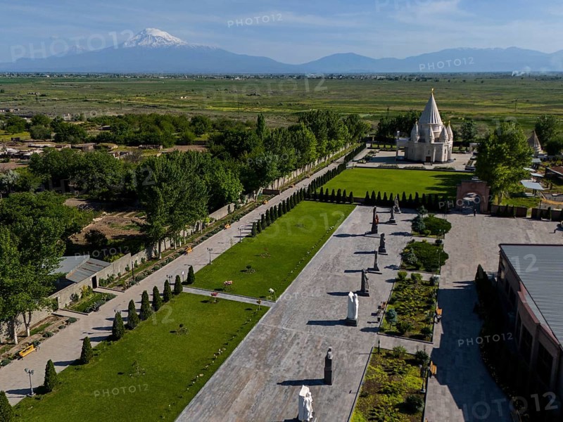 Spacious garden with statues and temple, surrounded by nature and mountains in the distance, aerial view, Yazidi temple, the largest Yazidi temple in the world is called Quba Mere Diwane, Aknalich, Aknalitsch, Armavir district, in the background Mount Aarat in Turkey, Armenia