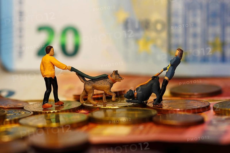 Miniature figure of man and woman with dogs and cash, North Rhine-Westphalia, Germany