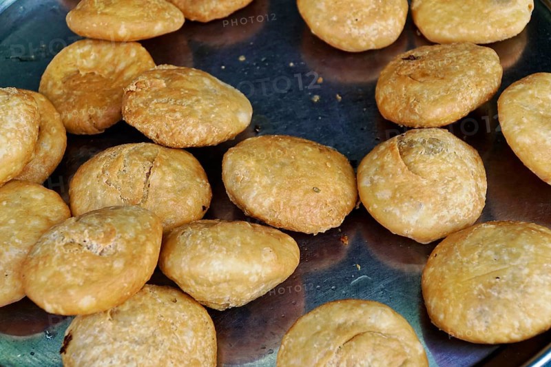 Udaipur, Rajasthan, North India, Asia, Kachori, a golden-brown and crispy snack, lies ready on a metal tray