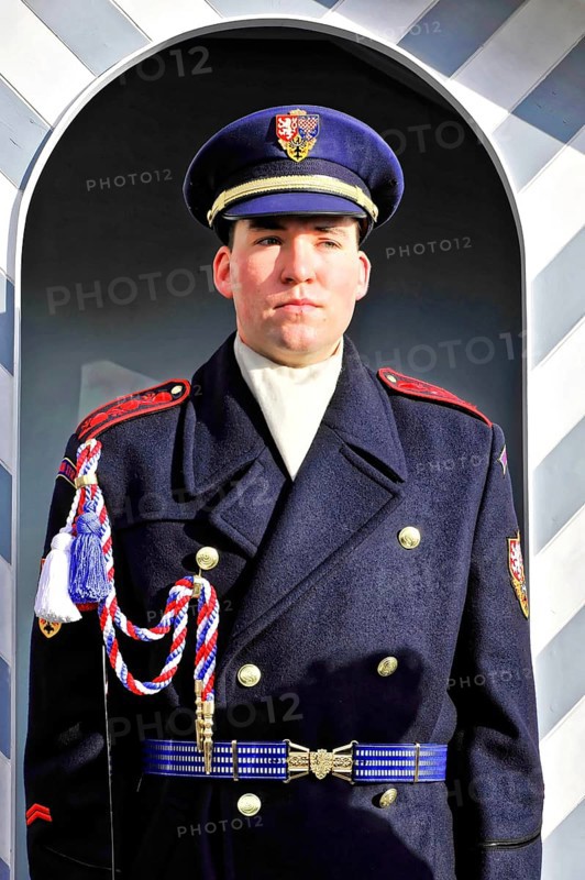Changing of the guard at Prague Castle, Hradcany, Prague, Czech Republic, Europe, Soldier in blue uniform stands upright in front of a decorative guardhouse