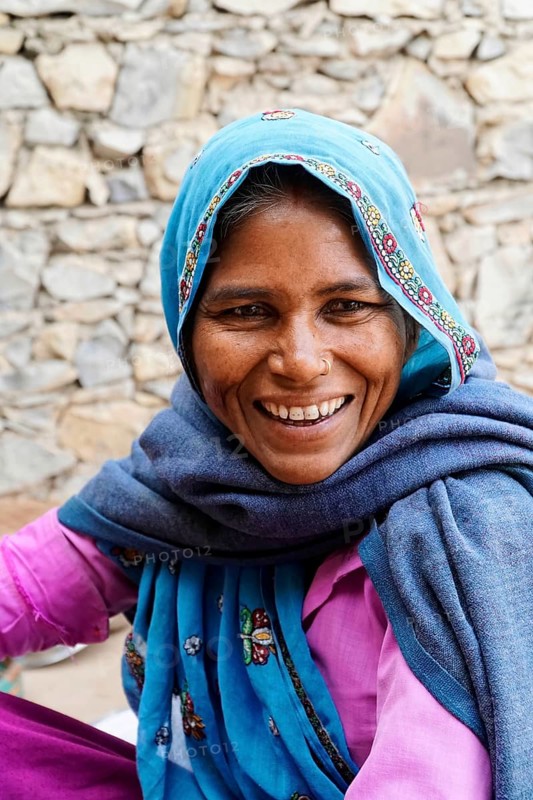 Sawai Madhopur, Kota, Rajasthan, North India, Asia, Woman in blue and pink clothes smiling with a headscarf and shawl, India