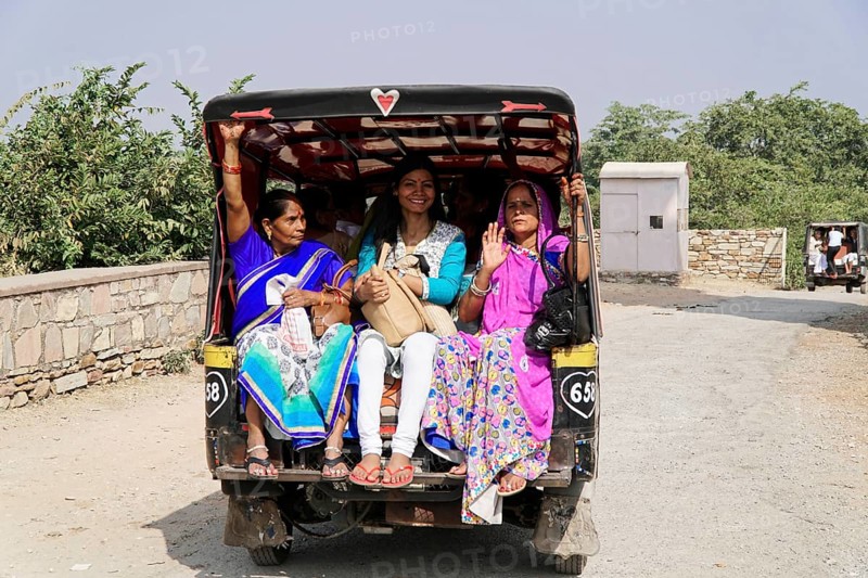 Kota, Rajasthan, North India, Asia, Women in traditional dress sit happily in the back of an autorickshaw, India