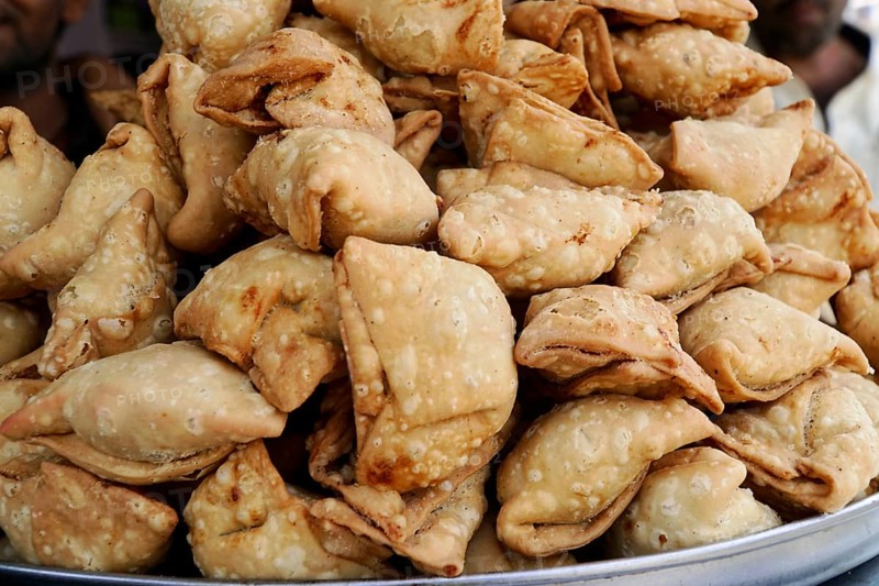 Kota, Rajasthan, North India, Asia, Stack of deep-fried samosas on a tray at the market, India