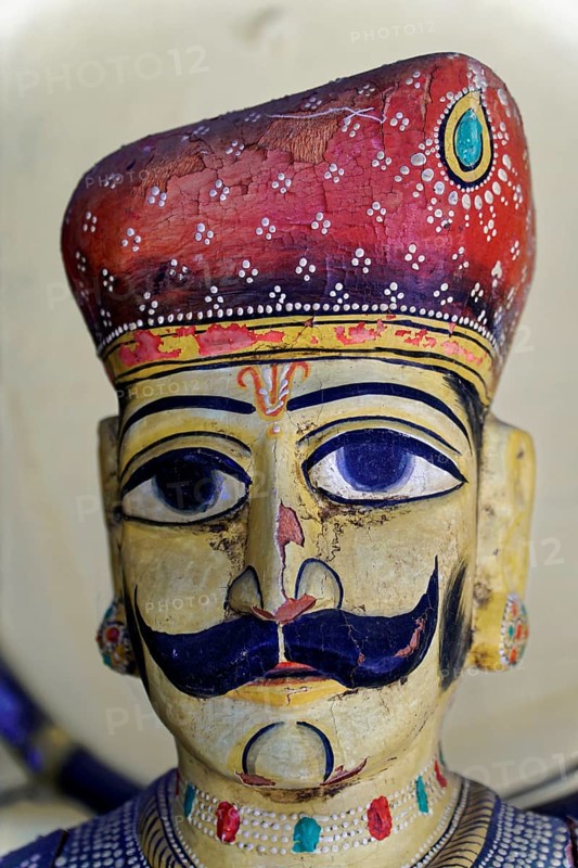 Udaipur, Rajasthan, North India, India, Asia, Traditional wooden figure with moustache and detailed headgear in bright colours