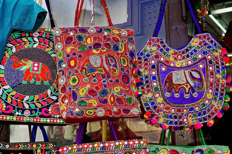 Udaipur, Rajasthan, North India, Asia, Different coloured embroidered bags with elephant patterns hang on display